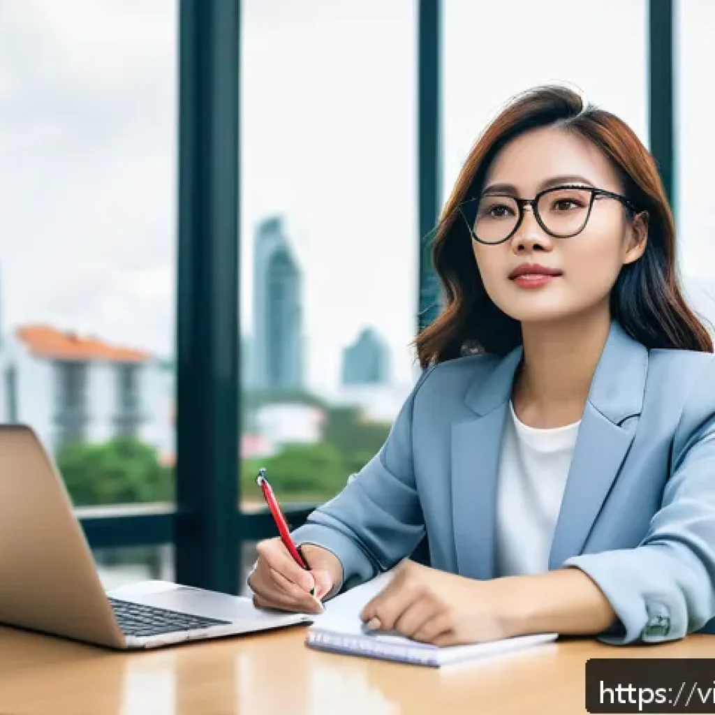 역경 후 새로운 가능성 모색하기 - A confident Vietnamese young professional woman sitting at a modern office desk with a laptop and no...