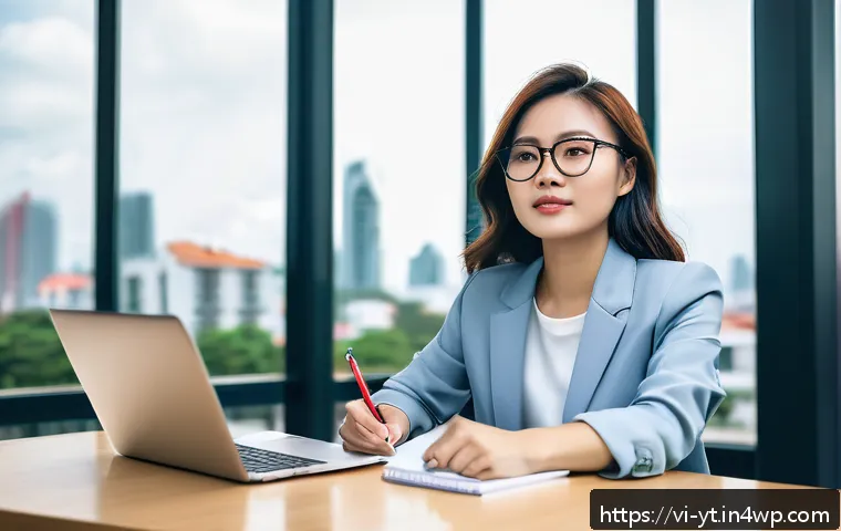 역경 후 새로운 가능성 모색하기 - A confident Vietnamese young professional woman sitting at a modern office desk with a laptop and no...
